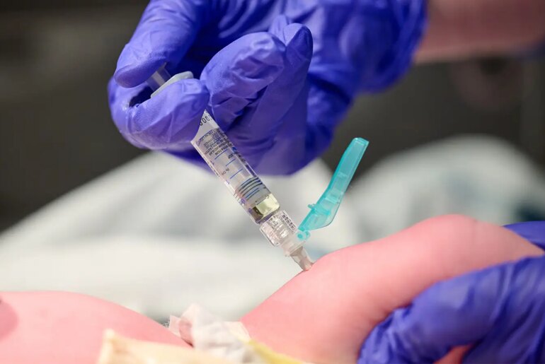 A photo of a nurse administering a Vitamin K shot to a newborn baby in Louisville, Kentucky.