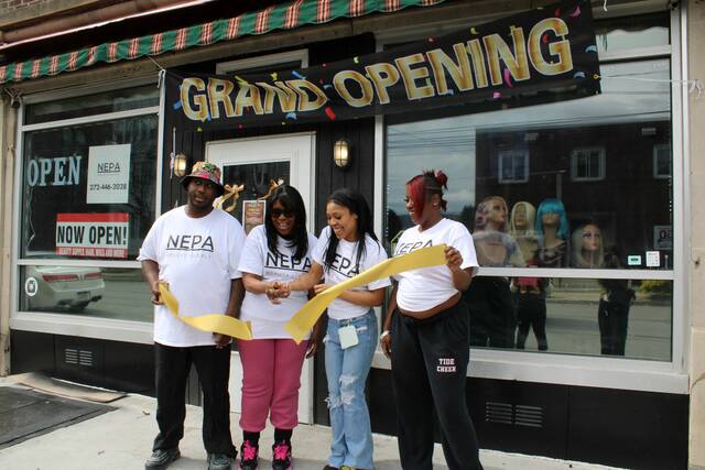 <p>Owners Trevon Jackson and Michelle Player and employees Tera Allen and Azalee Williams cut the ribbon, marking the grand reopening of NEPA Beauty Supply, at 438 N. Main St., Wilkes-Barre.</p>