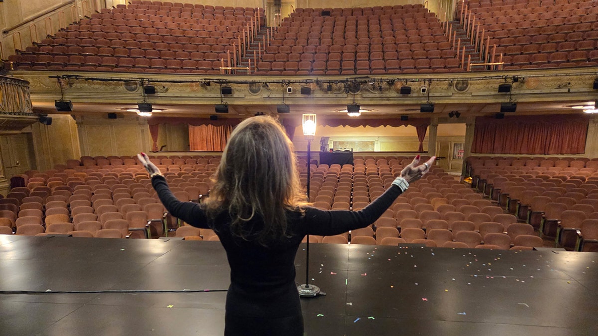 Susan Lucci performing to am empty audience on stage.