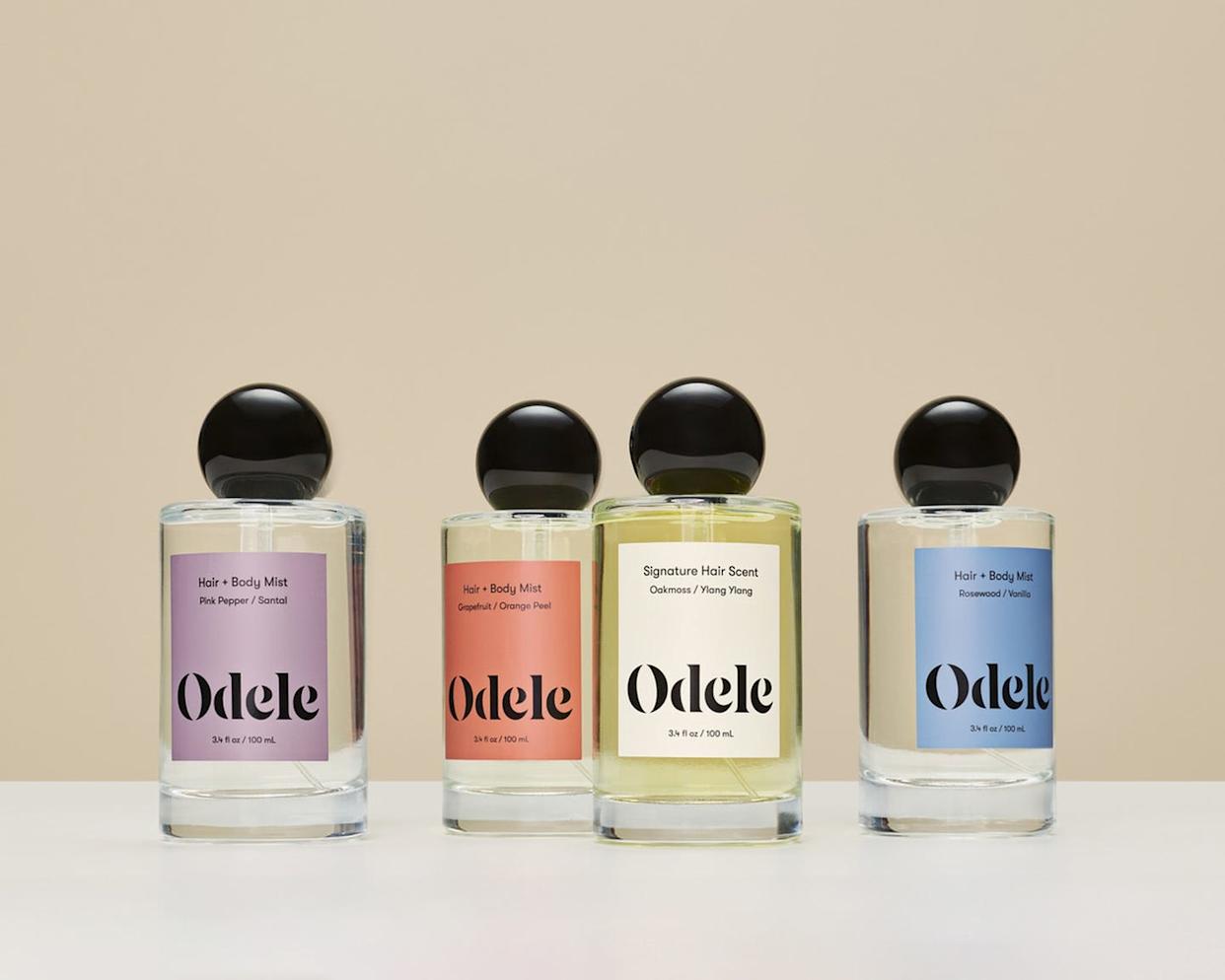 collection of hair and body mists displayed on a neutral background