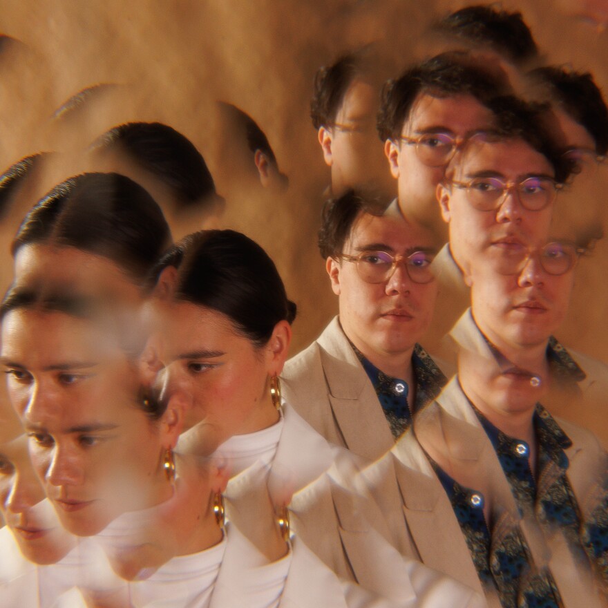 A woman and a man are pictured looking away from the camera with duplicates of their bodies swirling around them.