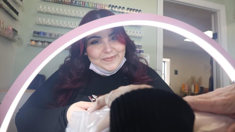 Kalin Sorto, of Bay Shore, runs her nail art business,...