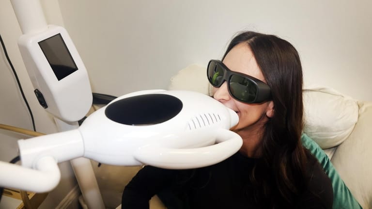 Licensed esthetician Nicole Xanthos, of Long Beach, demonstrates a teeth...