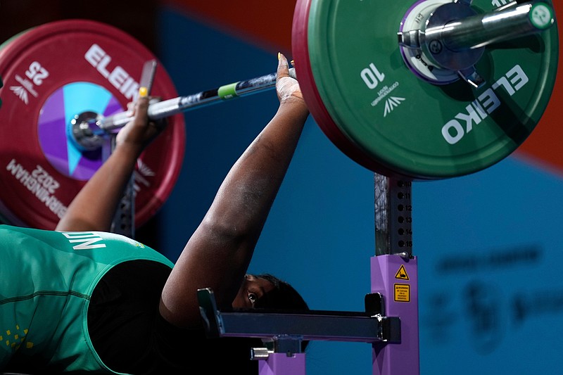 FILE - Thamar Gisele Mengue of Cameroon prepares to lift the weights during the women's heavyweight para powerlifting final at the Commonwealth Games at The NEC in Birmingham, England, Thursday, Aug. 4, 2022. (AP Photo/Aijaz Rahi,File)