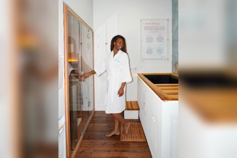 Image of a woman standing in a contrast therapy treatment room.