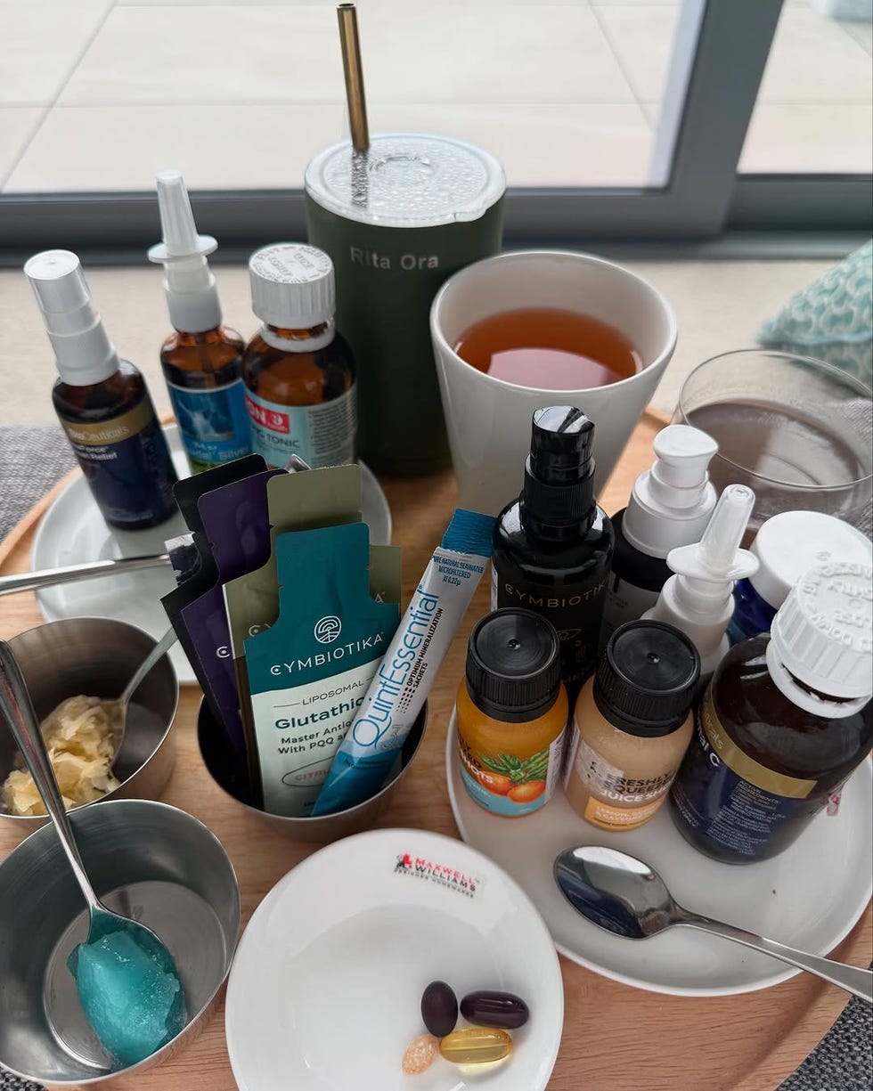 a collection of health supplements and beverages arranged on a tray