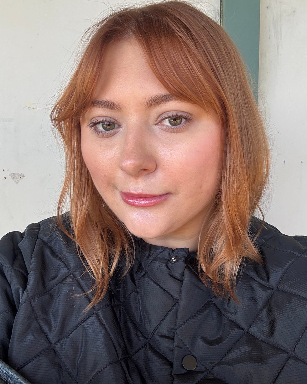 Person with obscured face wearing a black quilted jacket Person with obscured face wearing a black quilted jacket