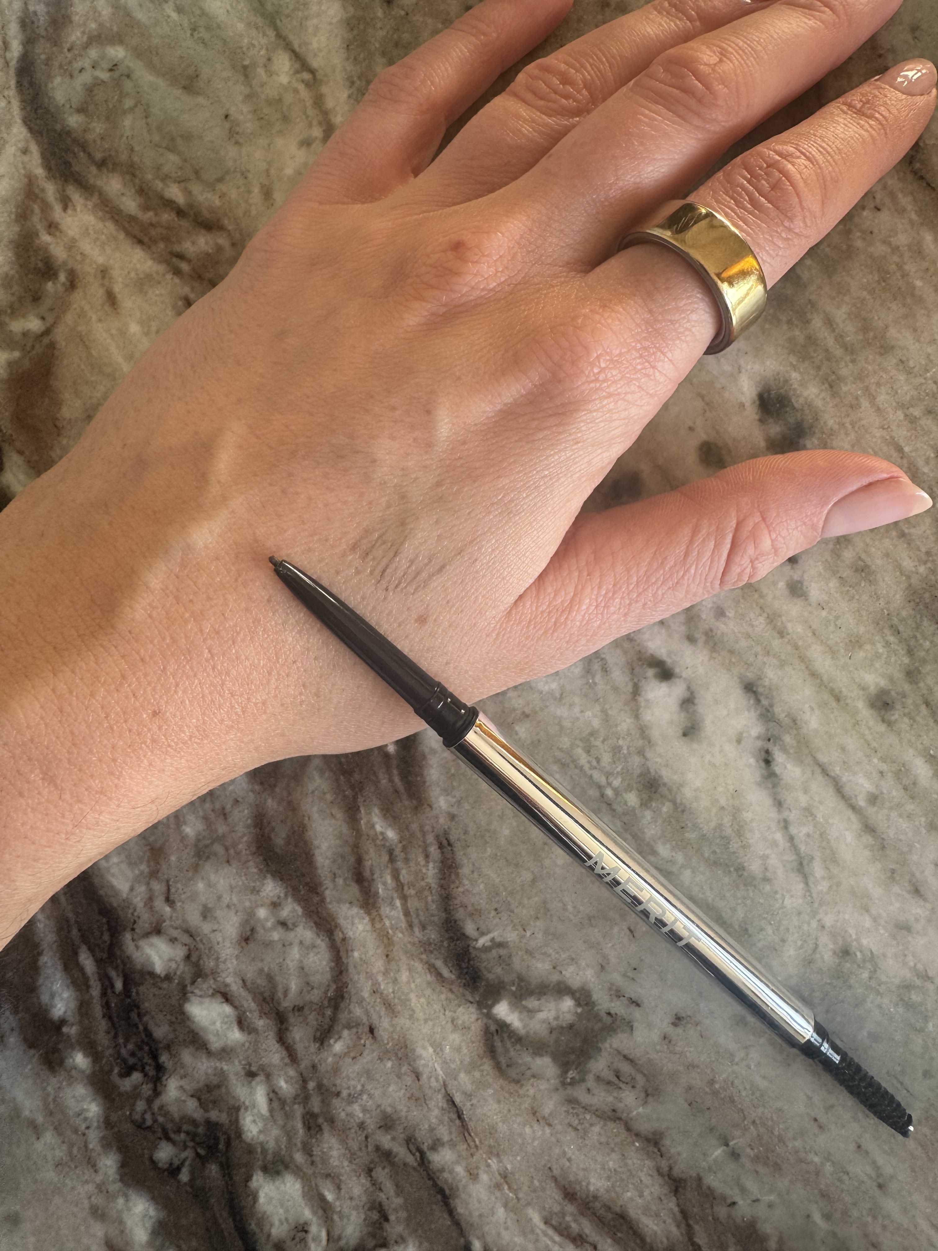 Beauty editor Eleanor swatching the Merit brow pencil on her hand
