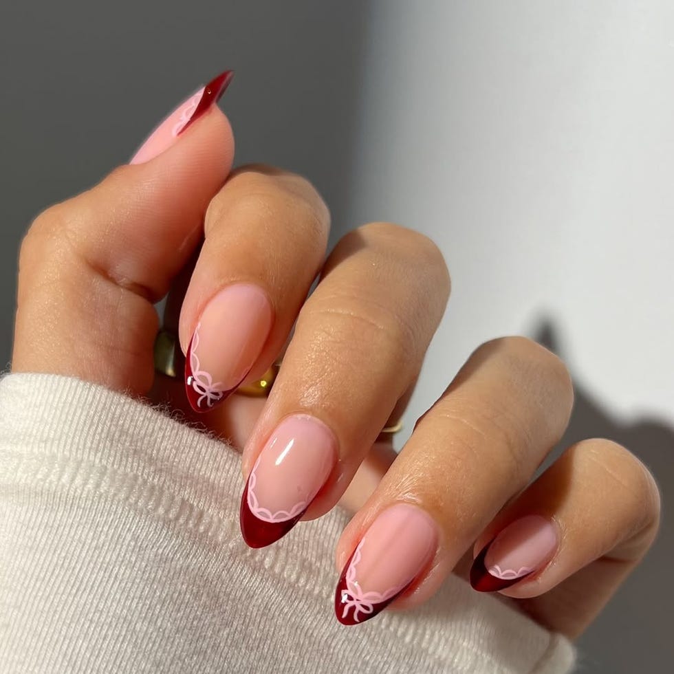 Nail design featuring shades of pink and red.