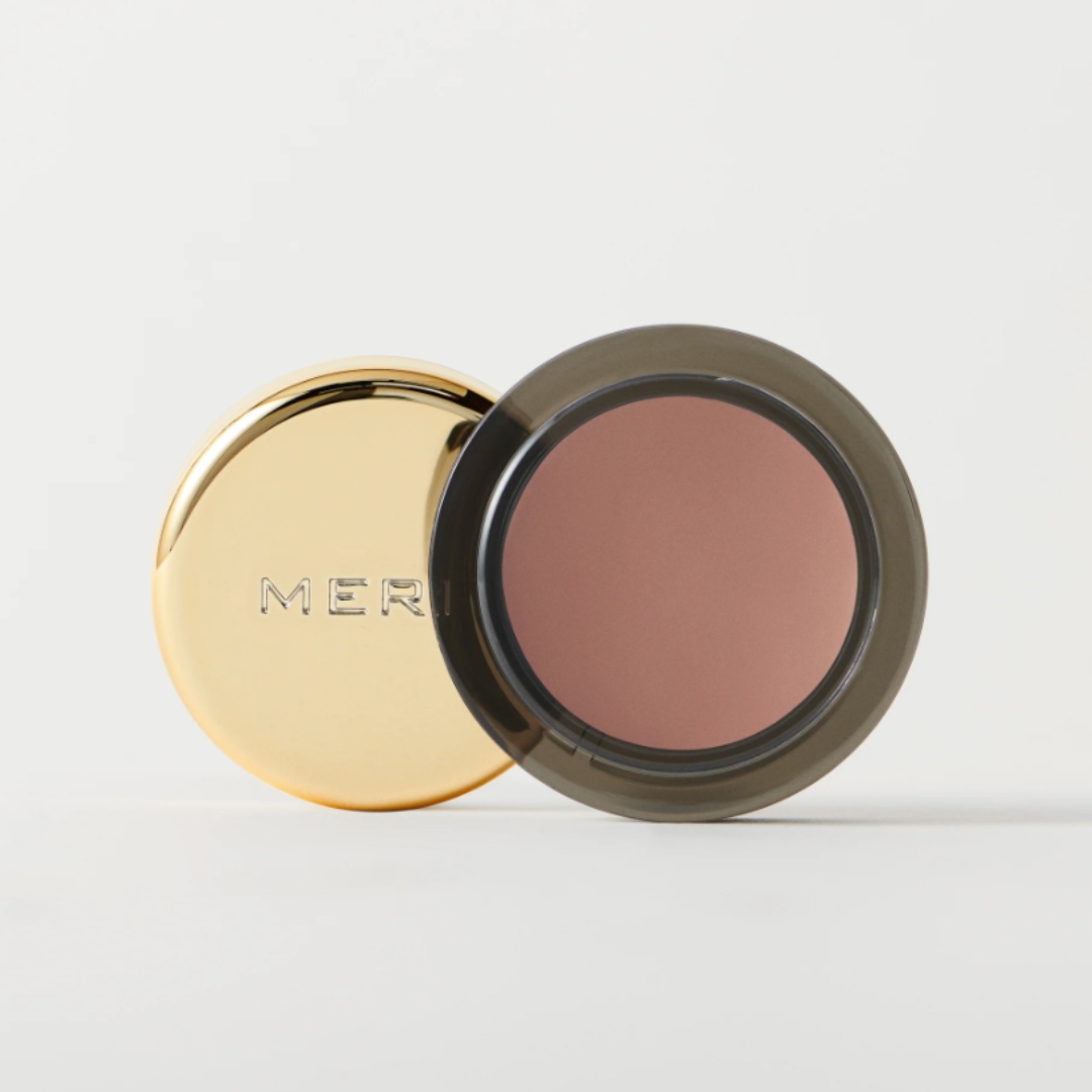 A product shot of the Merit Solo Shadow in shade Studio (a soft clay-brown colour), on a grey background