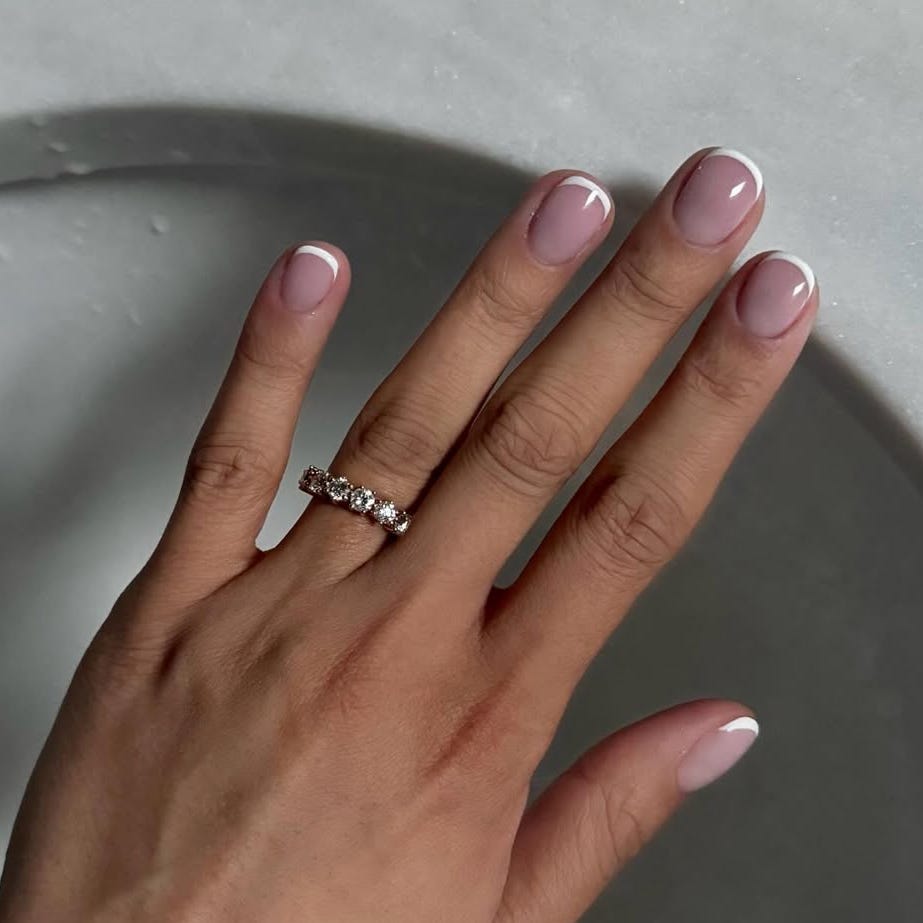 Hand with manicured nails and a ring