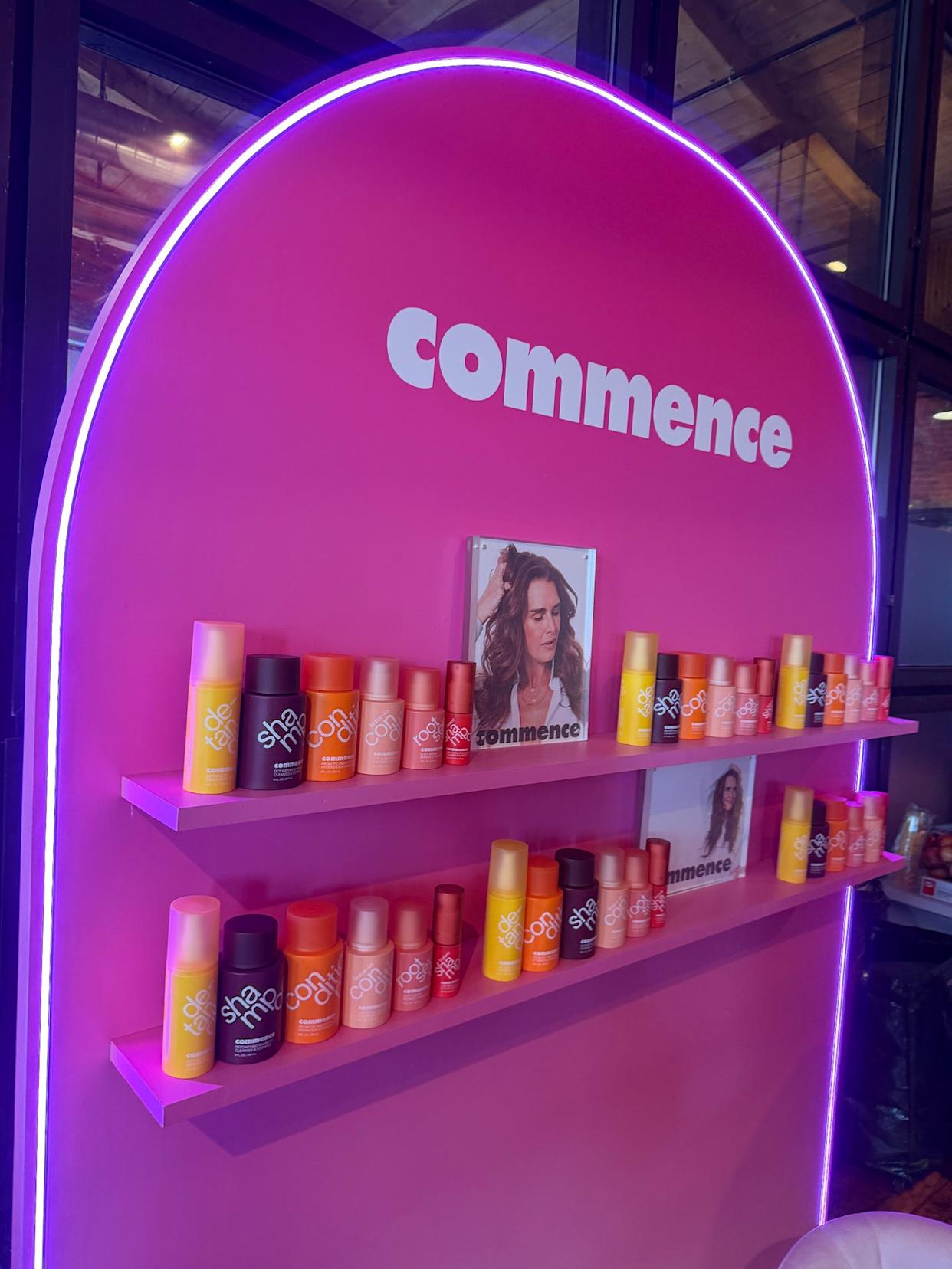 display of hair products on shelves against a pink wall