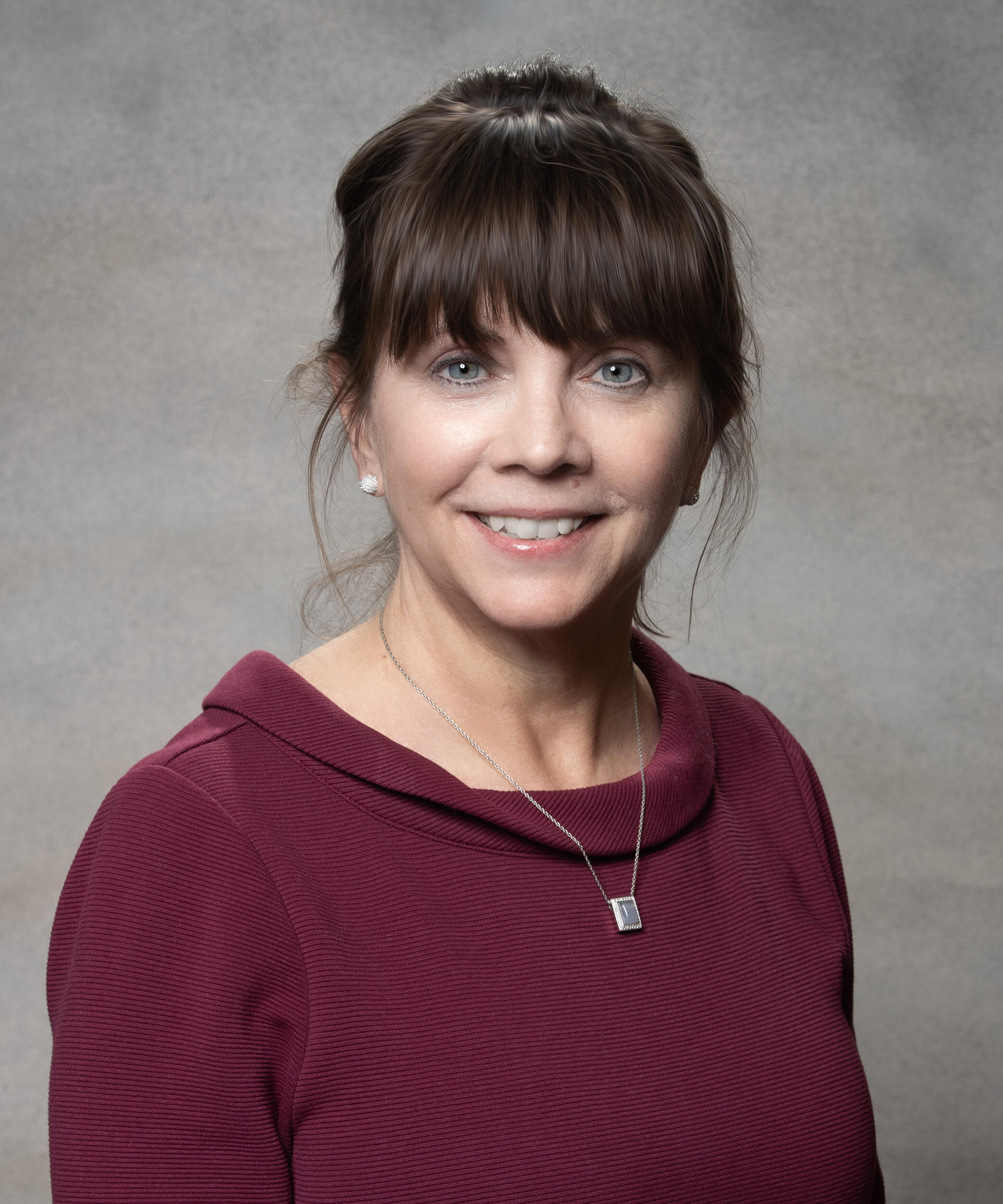 A photo of a woman from the chest up. 