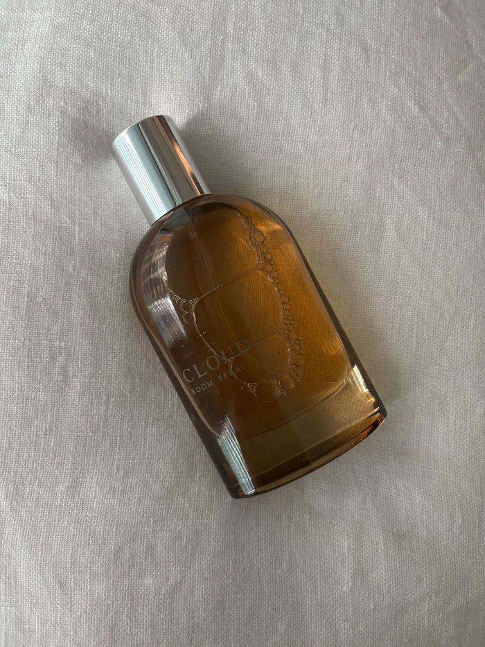 An M&S room spray on a white linen background