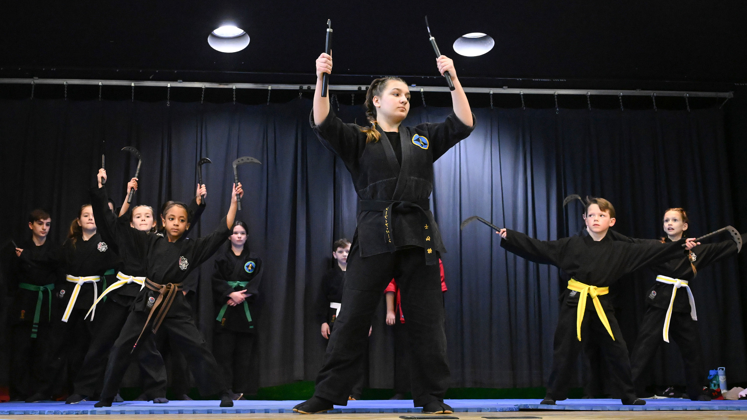 Students with Empire Dojo Abingdon display their skills during a martial arts demonstration at the Spring Into Wellness Fair, organized by Macaroni Kid Bel Air, at Harford Day School on Saturday. (Brian Krista/Staff)