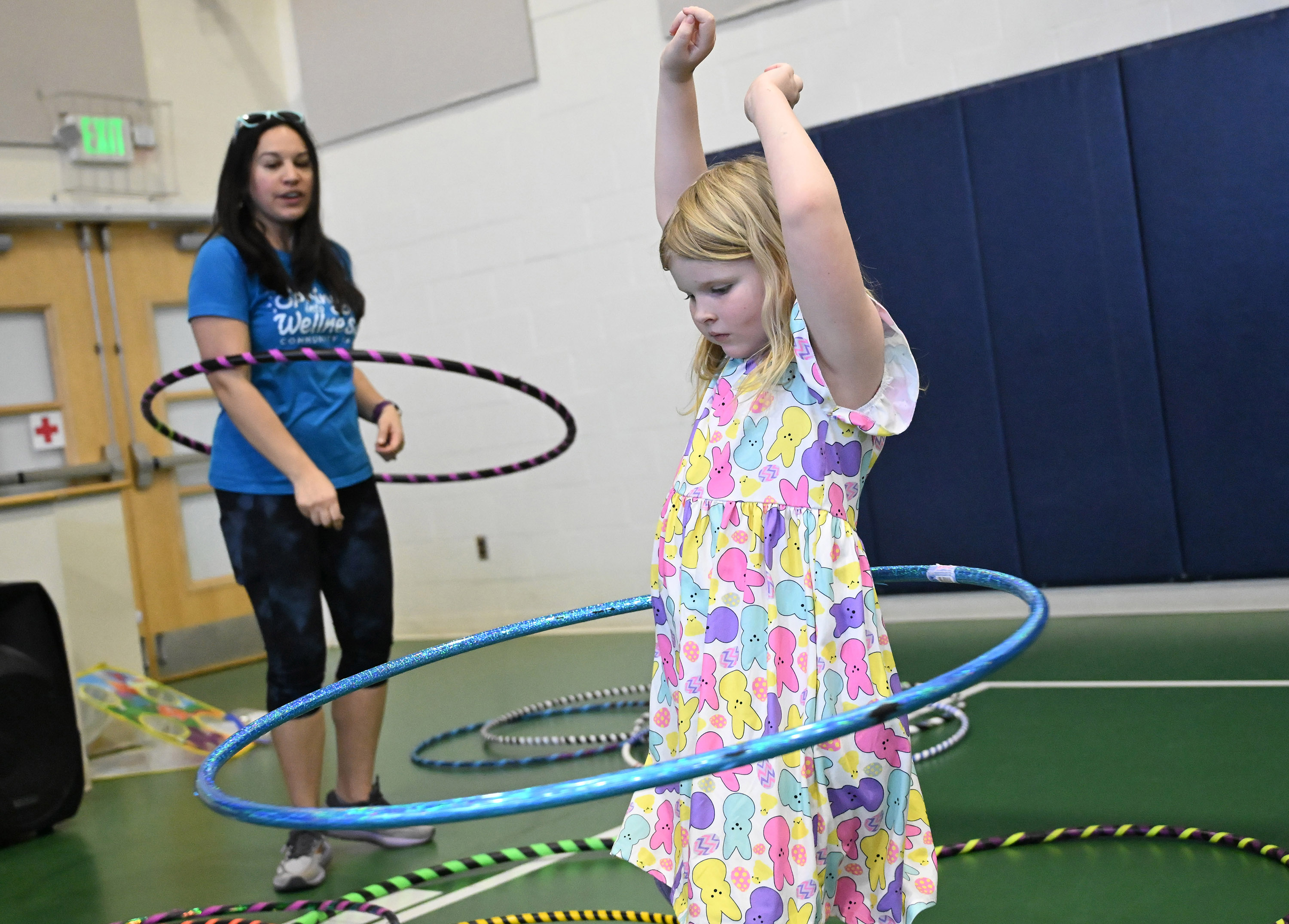 Six-year-old Emily Turner of Joppatowne perform with a hula hoop alongside Julia Capallo, publisher for Macaroni Kid Bel Air, organizer for the Spring Into Wellness Fair at Harford Day School on Saturday. (Brian Krista/Staff)