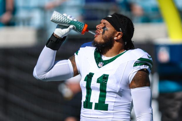 FILE - New York Jets linebacker Jermaine Johnson warms up before an NFL football game against the Jacksonville Jaguars, Dec. 14, 2025, in Jacksonville, Fla. (AP Photo/Gary McCullough)