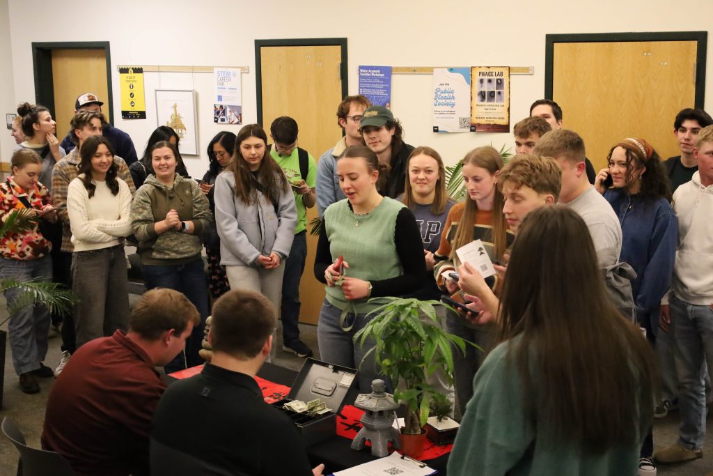 Students in a line waiting to start DIY Bonsai Night.