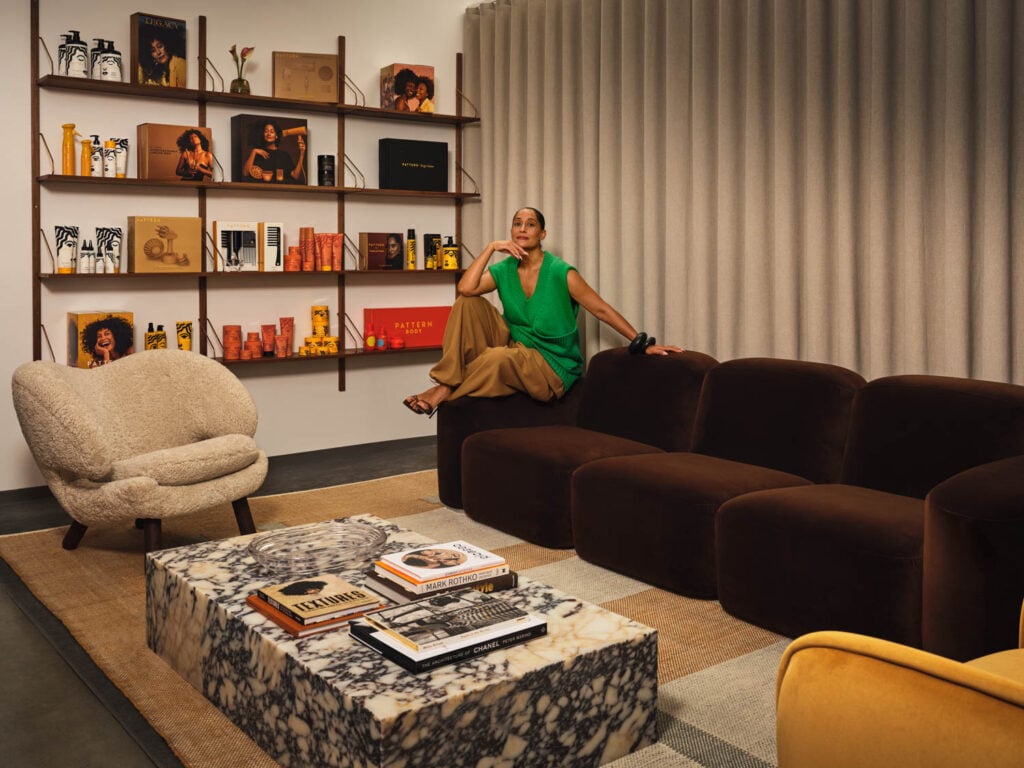 tracee ellis ross on a dark brown couch