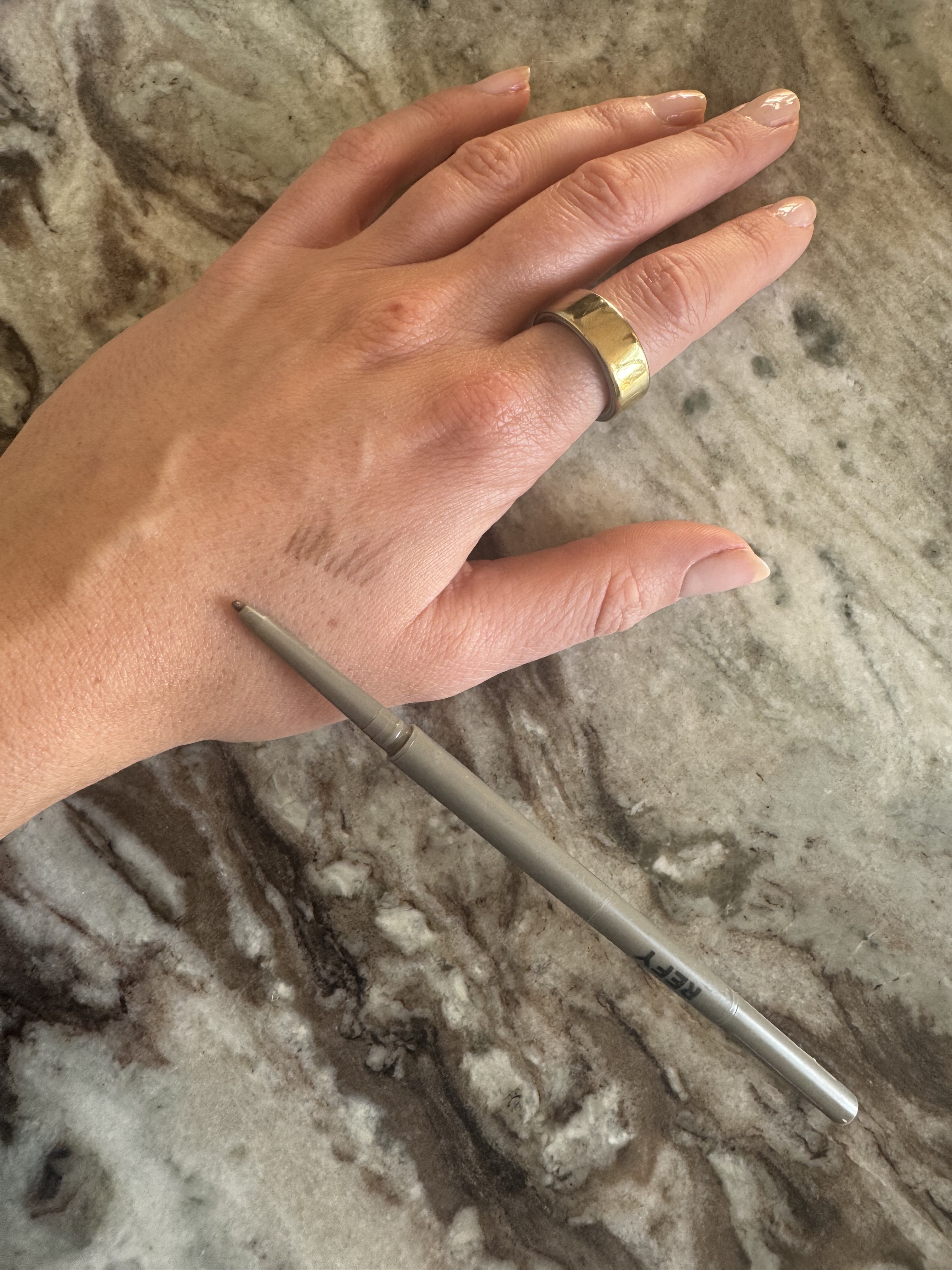 Beauty editor Eleanor swatching the Refy brow pencil on her hand