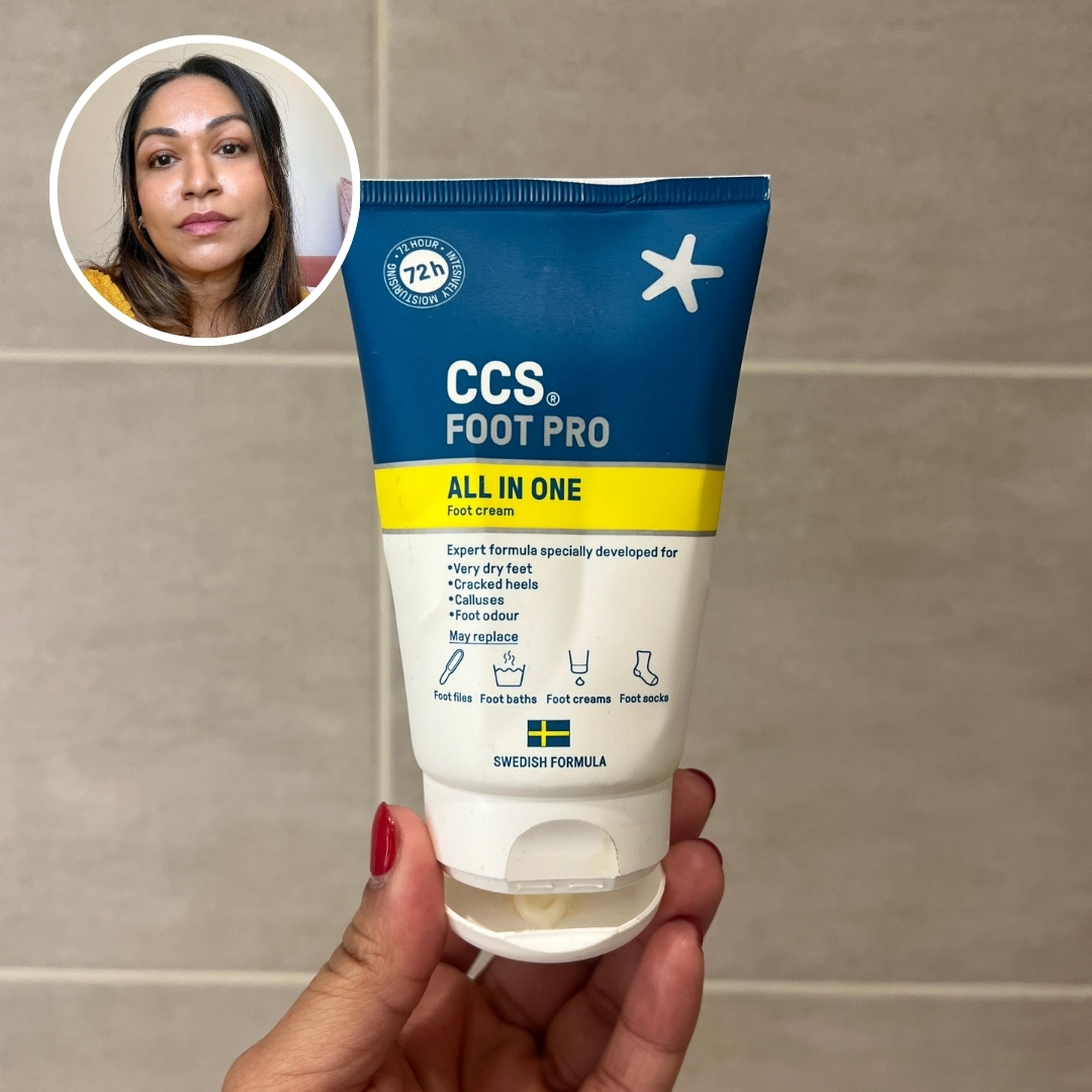 Hand holding an empty tube of CCS Pro All-In-One Foot Cream, with circular photo of Aleesha Badkar in top left corner
