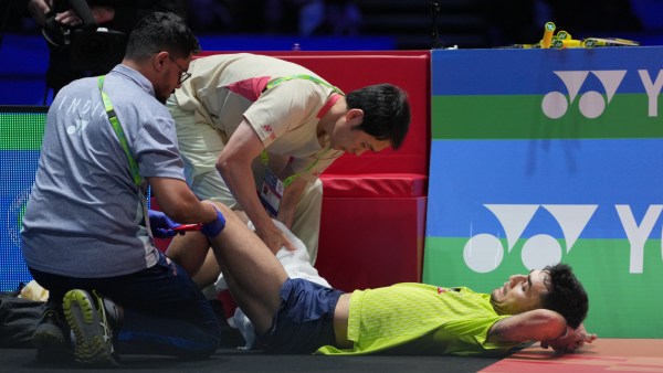 India's Lakshya Sen receives medical treatment during his men's singles match against Canada's Victor Lai during All England semifinal match. (PHOTO: AP)