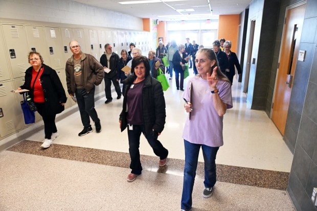Stacey Brennan, right, from the Center at Spring Drive, and Kim Haas, left, director of the center, lead participants in a walking bingo exercise during the Wellness Council of Boyertown's 19th annual Wellness Fair at the Boyertown Area Senior High School on Saturday, March 14, 2026.(BILL UHRICH/READING EAGLE)