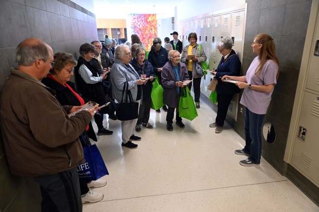 Stacey Brennan, right, from the Center at Spring Drive, calls bingo numbers in a walking bingo exercise during the Wellness Council of Boyertown's 19th annual Wellness Fair at the Boyertown Area Senior High School on Saturday, March 14, 2026.(BILL UHRICH/READING EAGLE)