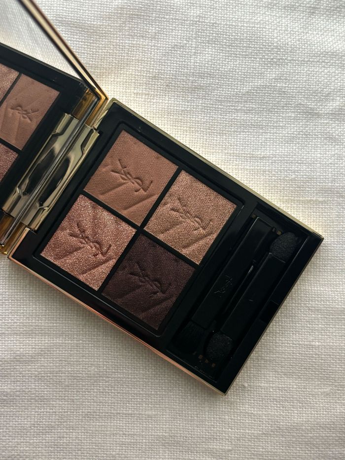 A YSL brown eyeshadow palette on a white background
