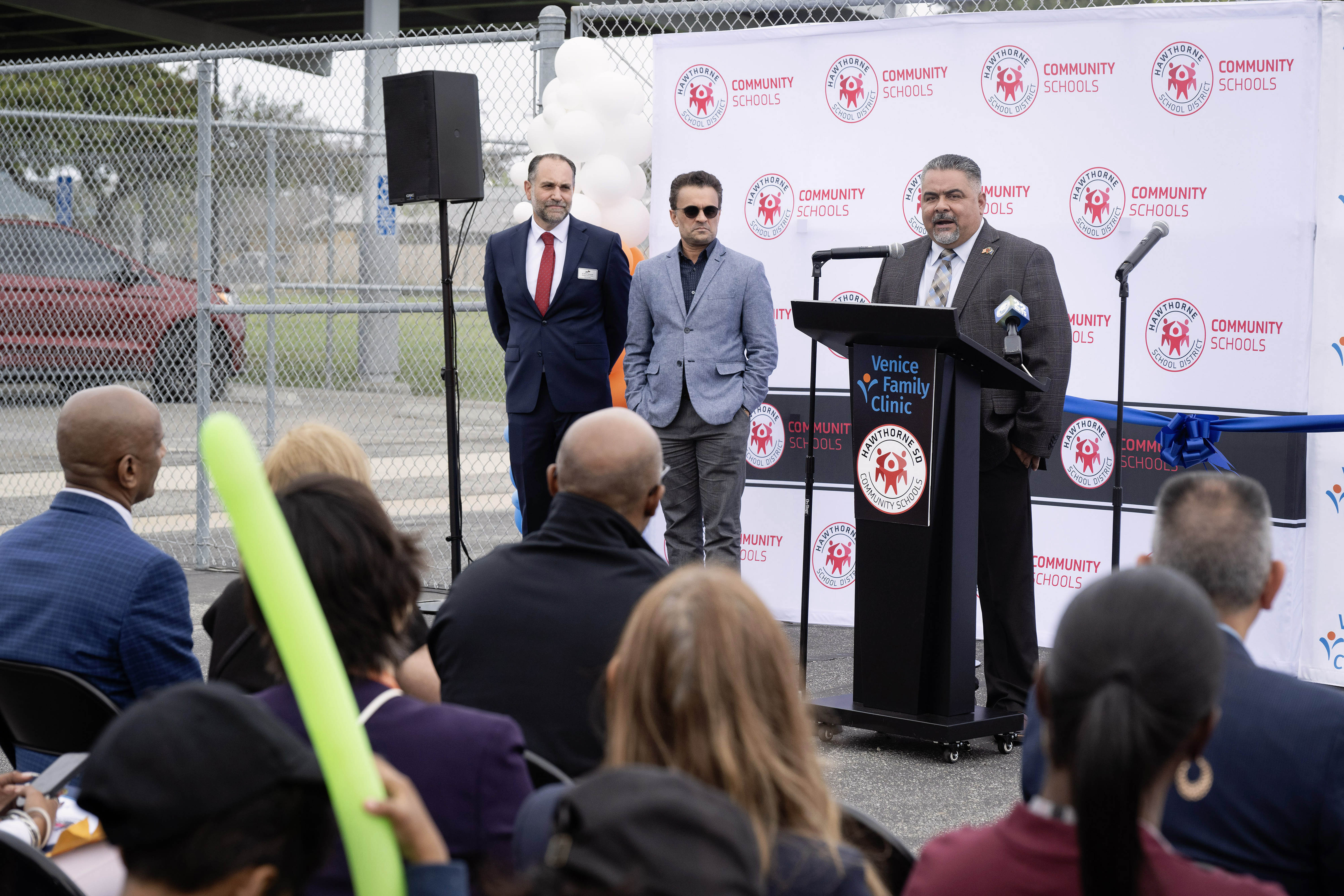 Board Member Luciano Aguilar, right, speaks during the grand opening...