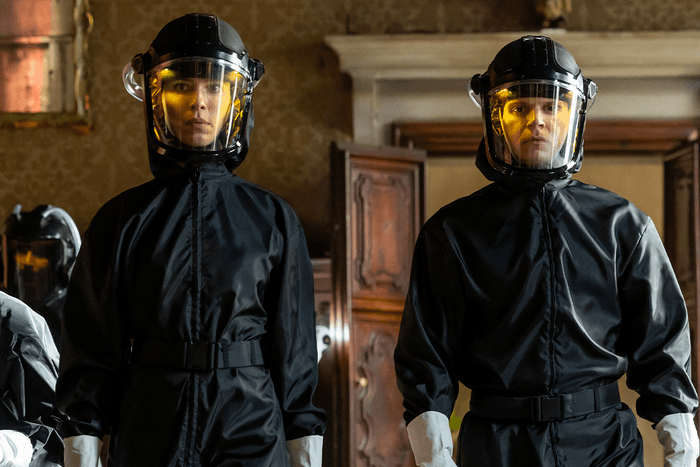 Rebecca Hall and Evan Peters in Hazmat suits in The Beauty.