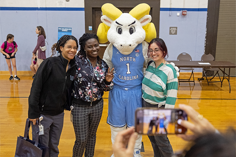 The mascot for U.N.C. Chapel Hill Rameses, poses with staff and faculty at the Wellness Expo on campus.