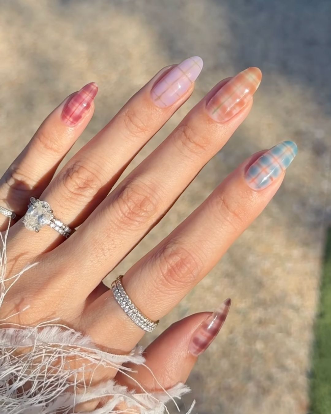 An image of Zola's nails with pastel plaid nail art.