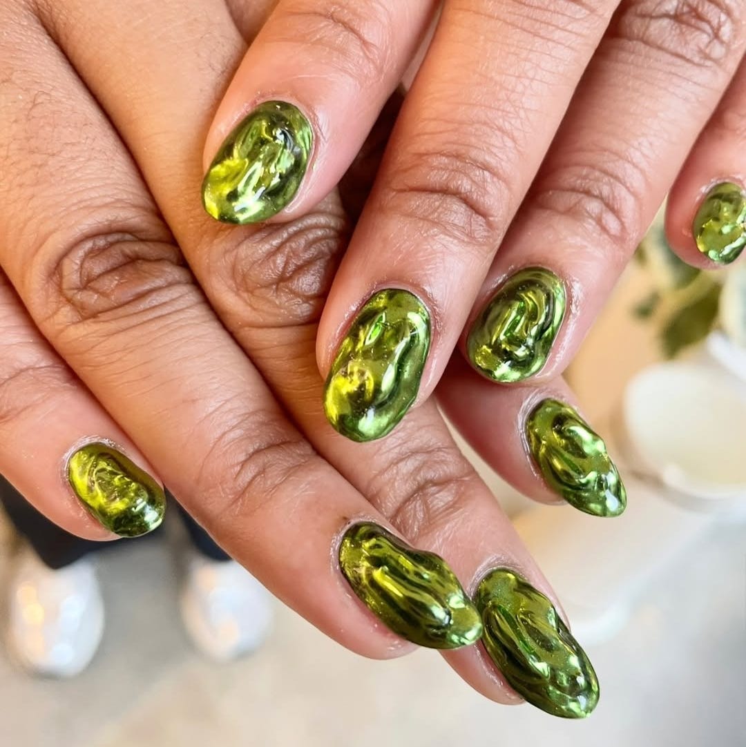 stylish green marbled nail design on hands
