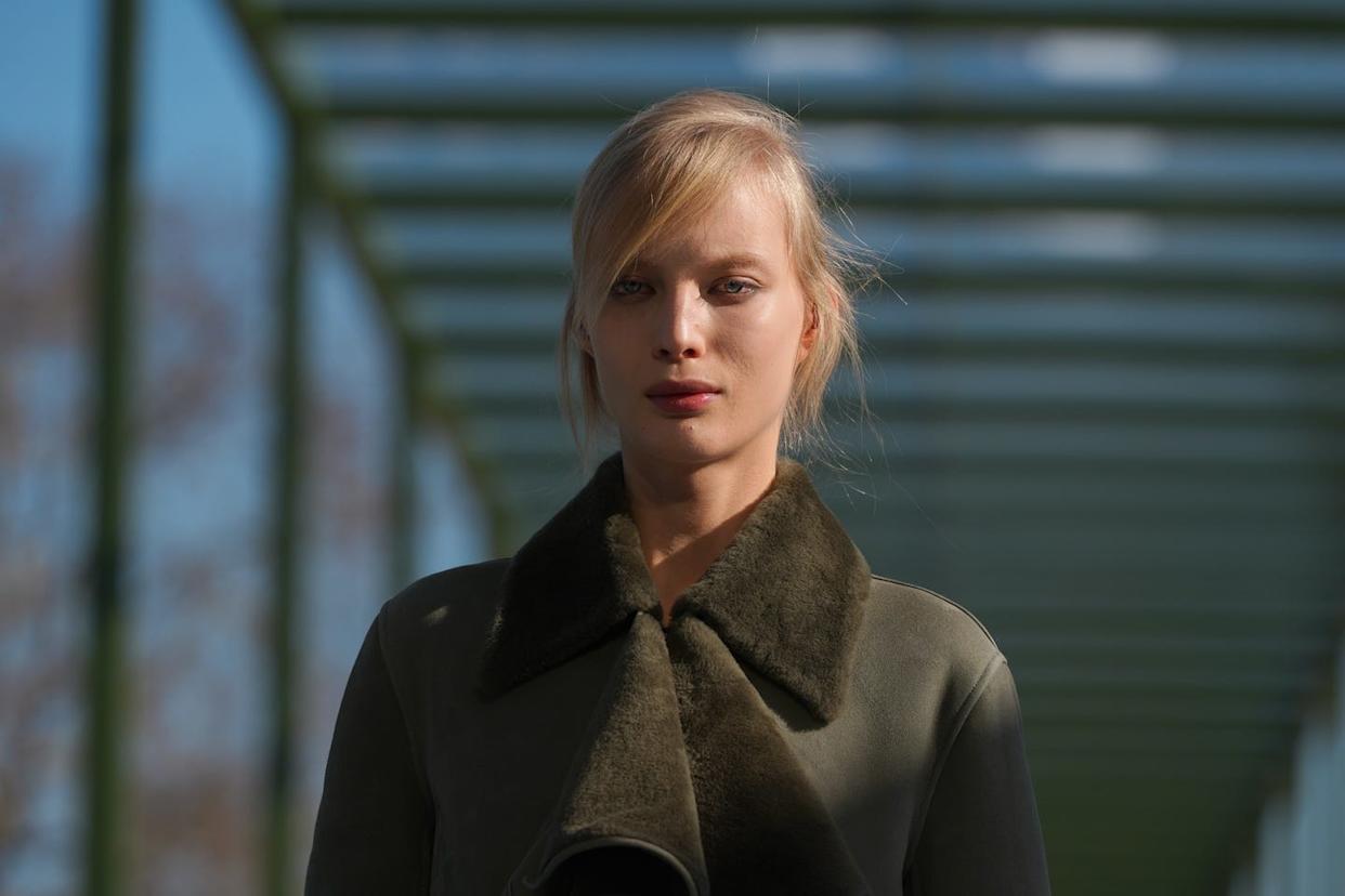 Individual standing under a structural walkway.