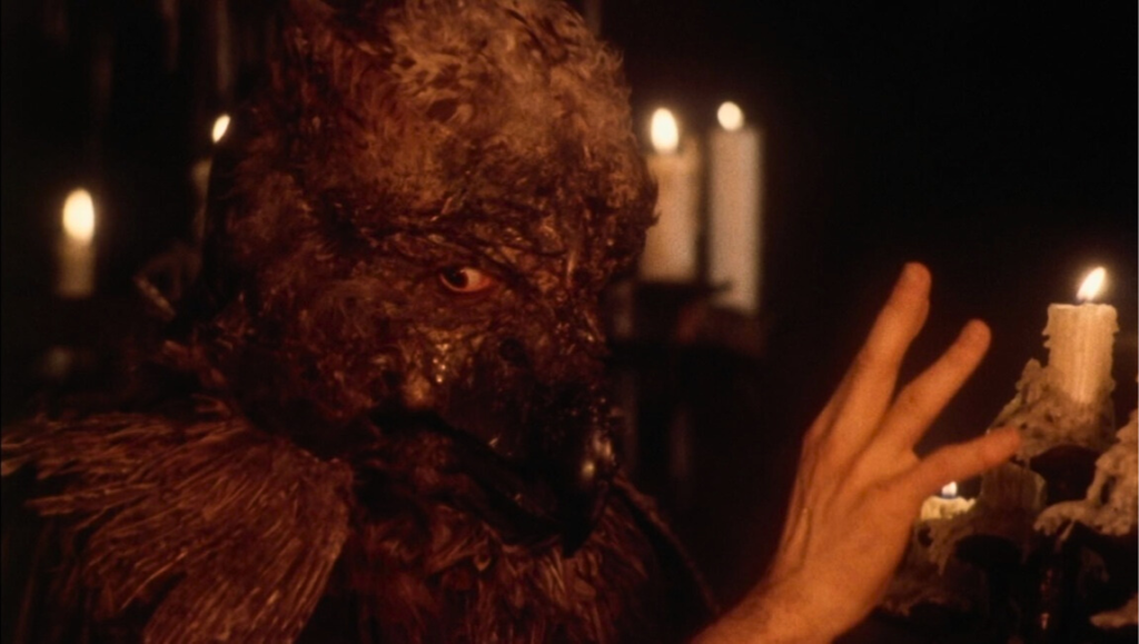 Beauty and the Beast movie scene: The Beast with bird-like features in a dimly lit room with candles.