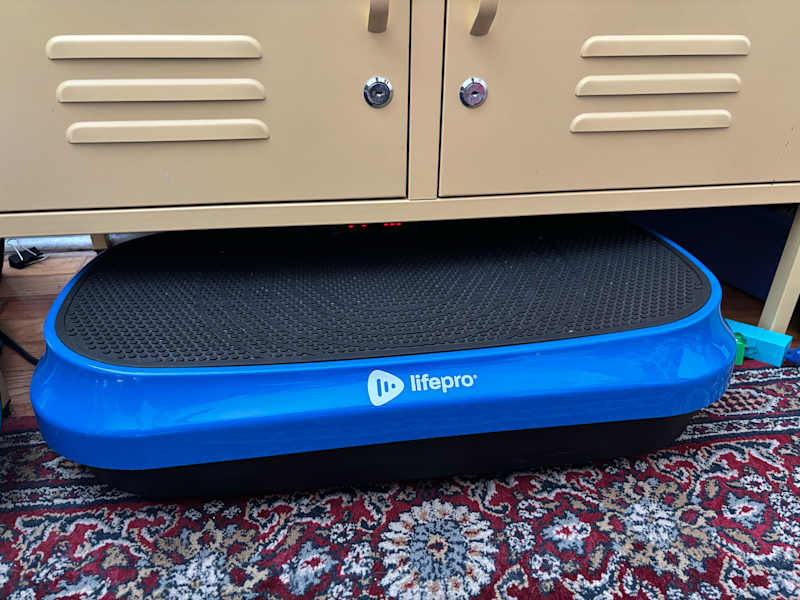 LifePro vibrating pad stored in living room.