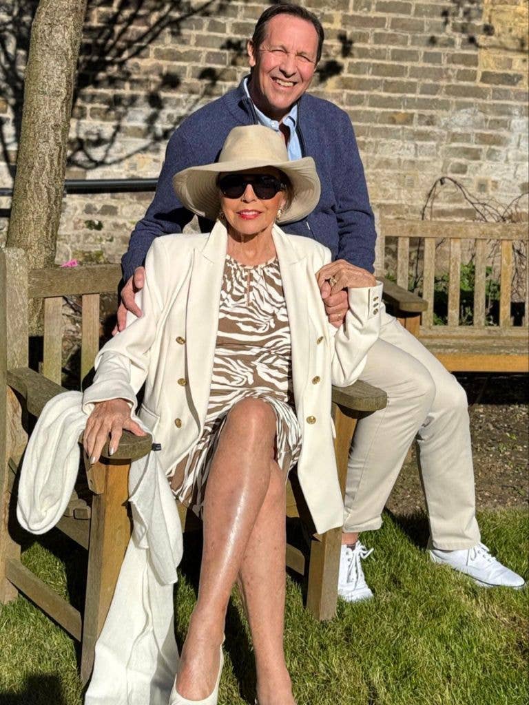 Dame Joan Collins and husband Percy Gibson on a park bench in London