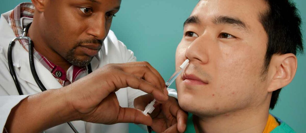 A healthcare practitioner administering a nasal spray vaccine. Credit: CDC