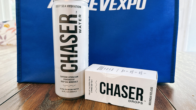 Chaser water can and drops on wooden table in front of a blue bag from the Alt Bev Expo