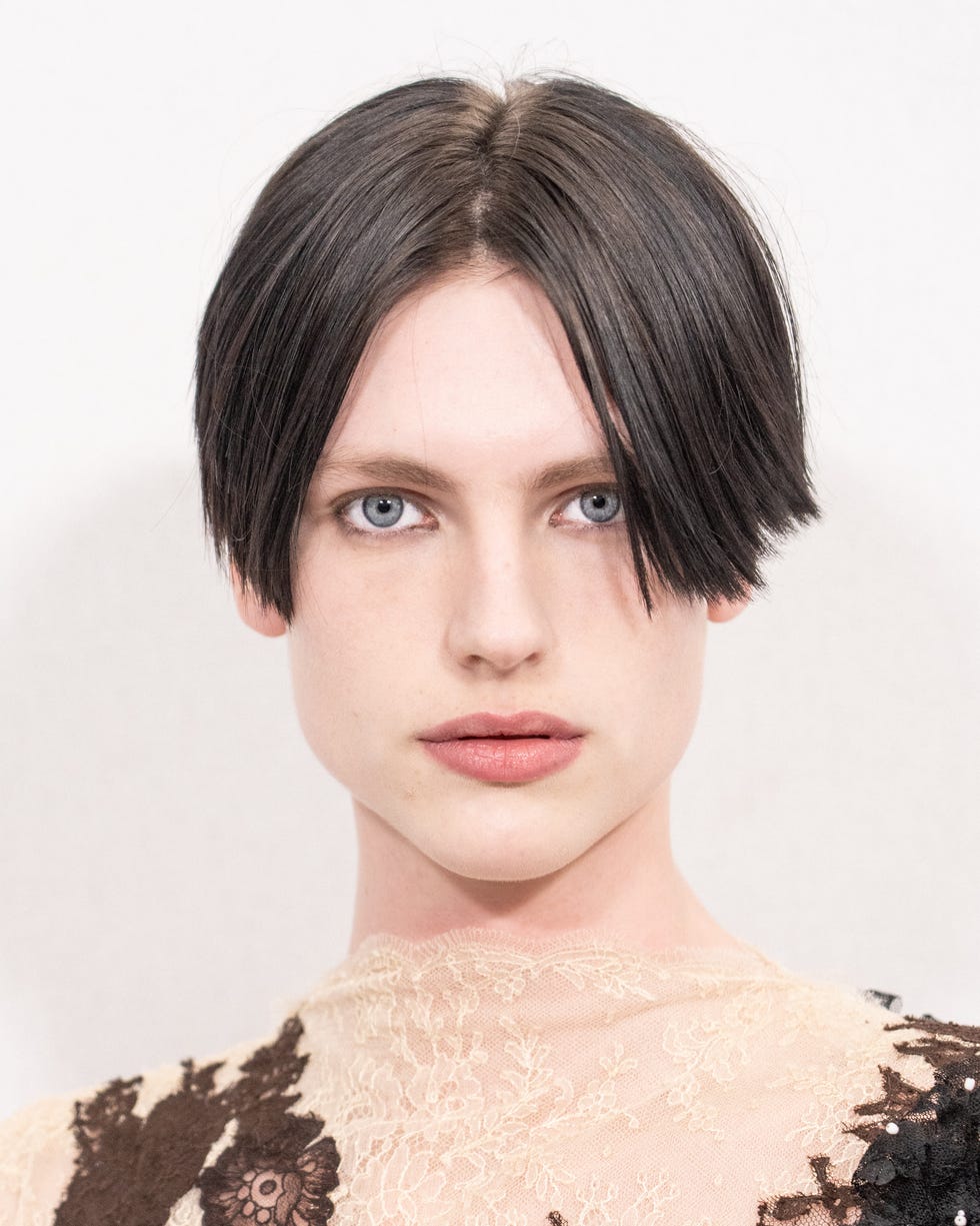 person wearing a floral lace top