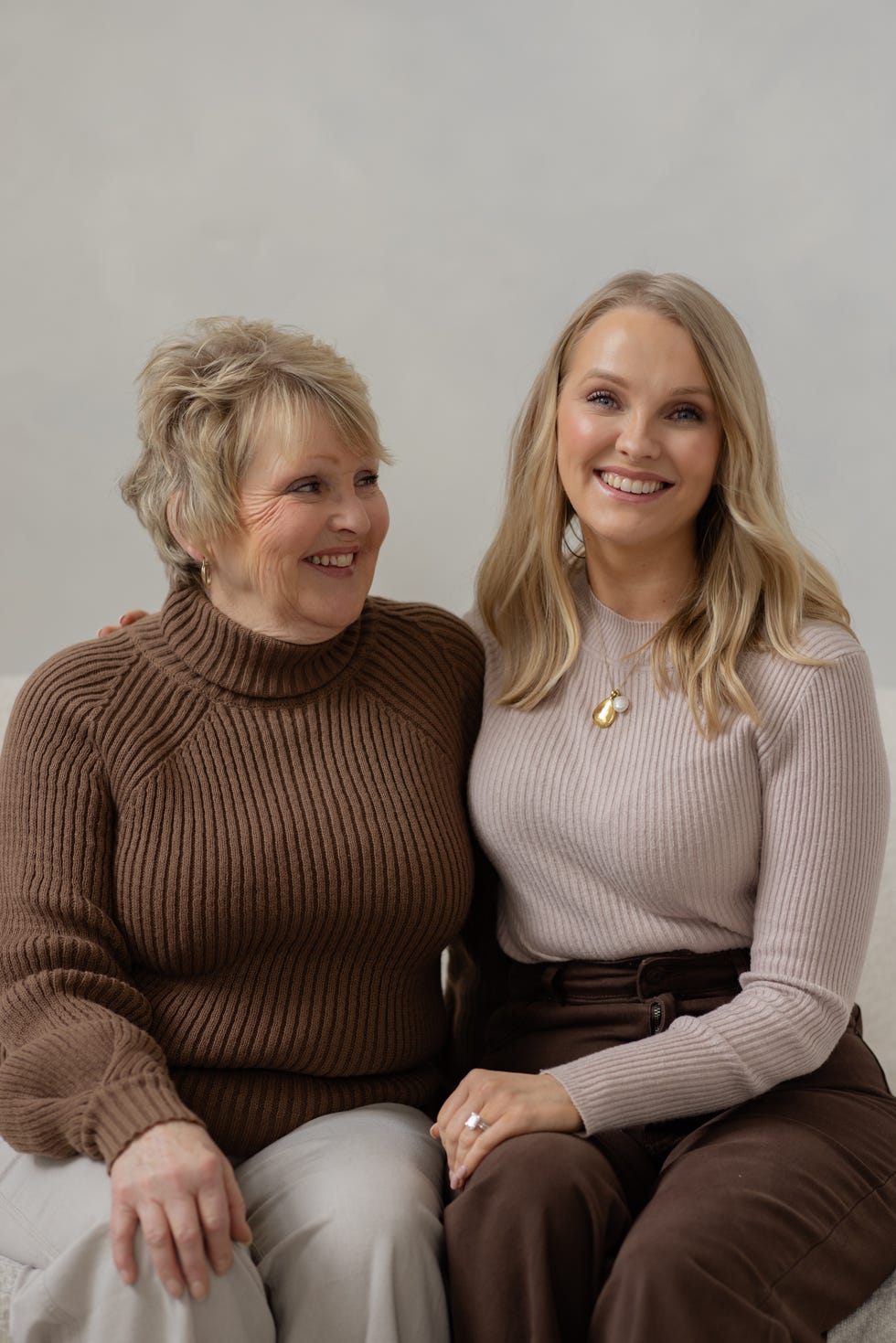 two women seated together sharing a close bond