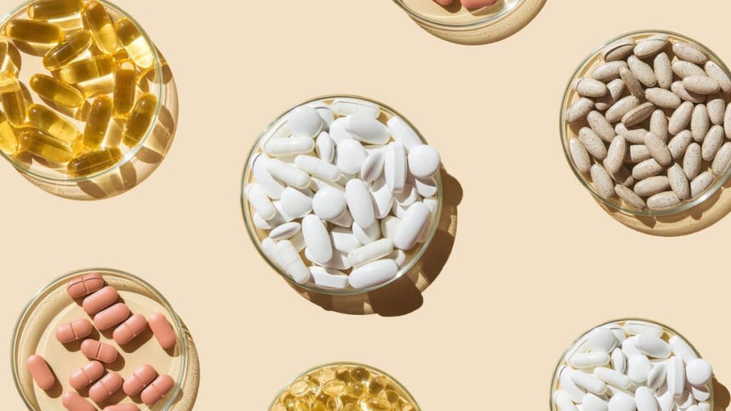 Close-up of various pills and capsule supplements for fatty liver on tan background