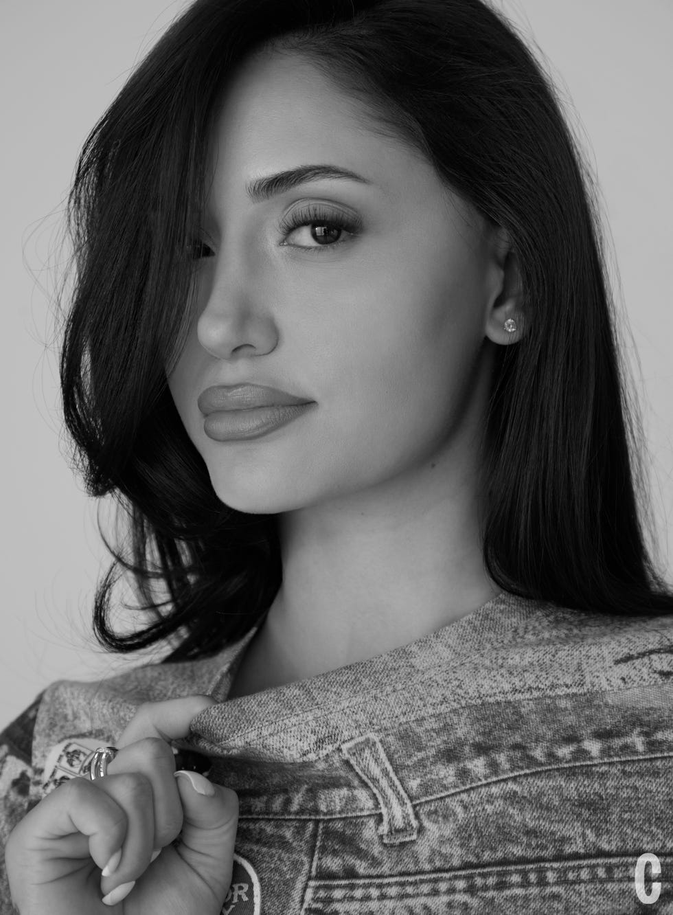 Portrait with obscured face, featuring a hand holding a collar.