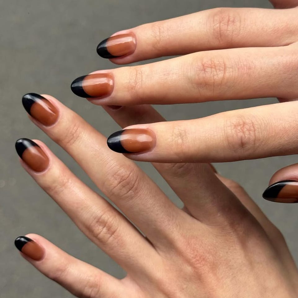 Stylish manicure featuring brown and black nail polish.