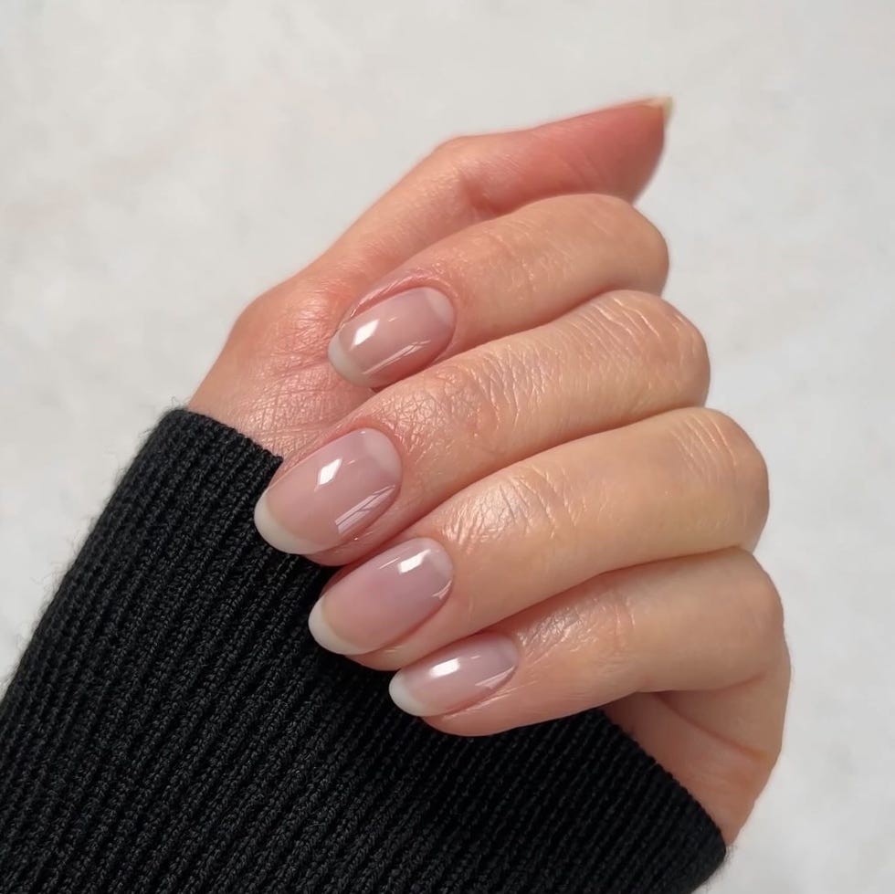 A hand with well-manicured nails showcasing a natural look.