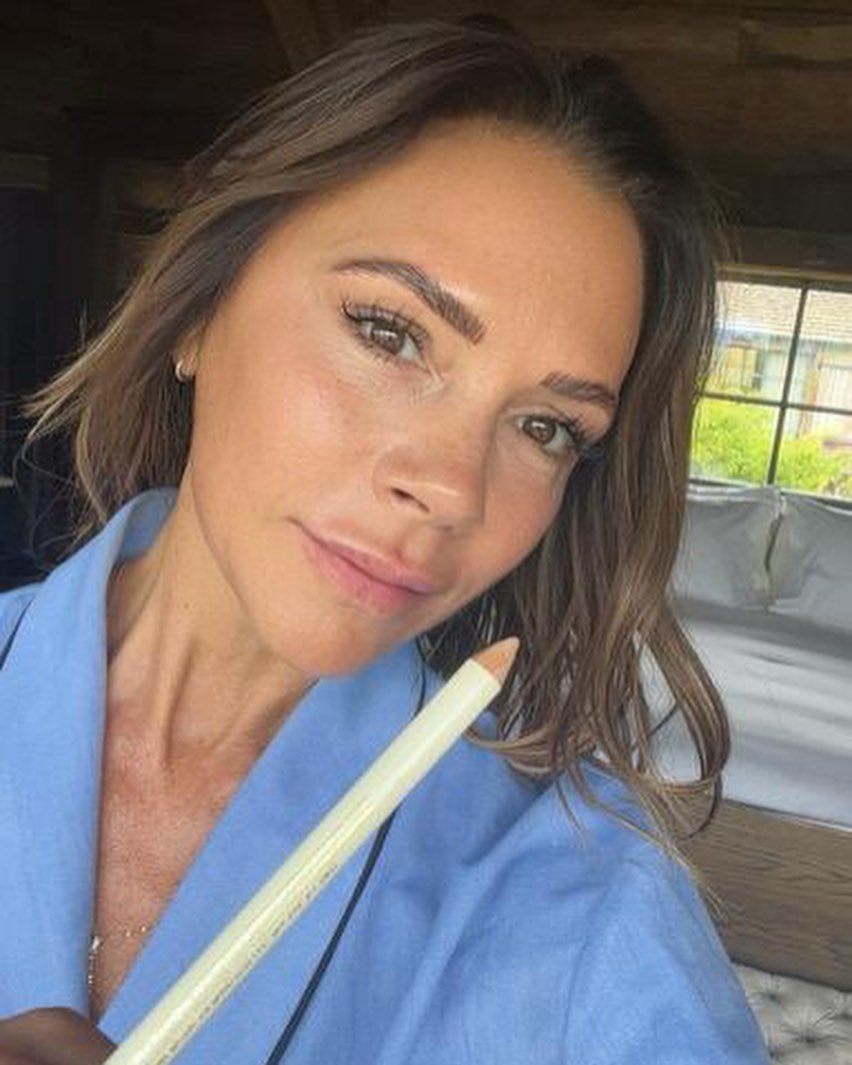 A photo of Victoria Beckham posing for a selfie with her brightening waterline eyeliner pencil