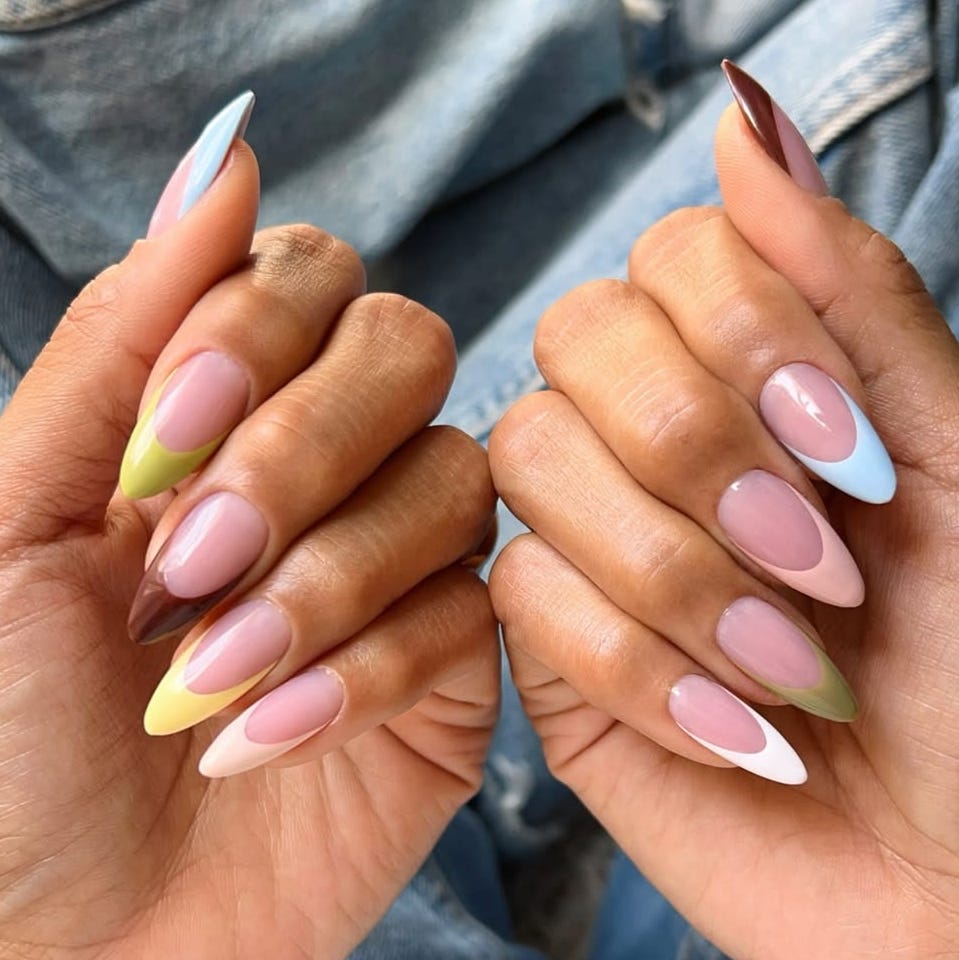 Colorful manicure showcasing various nail designs.