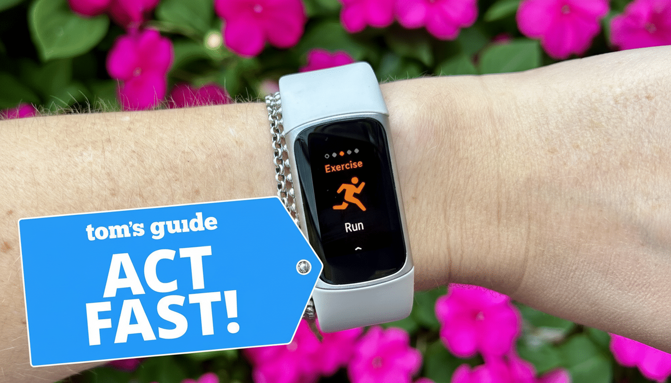 A close-up of a persons wrist wearing a light gray fitness tracker with a silver chain detail, displaying Exercise and Run with an orange running icon on its screen. A blue banner with toms guide ACT FAST! is overlaid in the bottom left corner. The background features vibrant pink flowers and green foliage.
