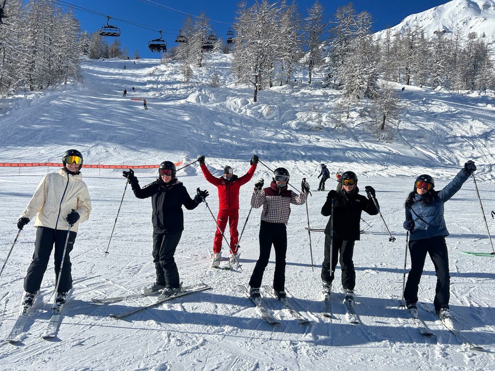 group of skiers on snowy slopes girl powder retreat review